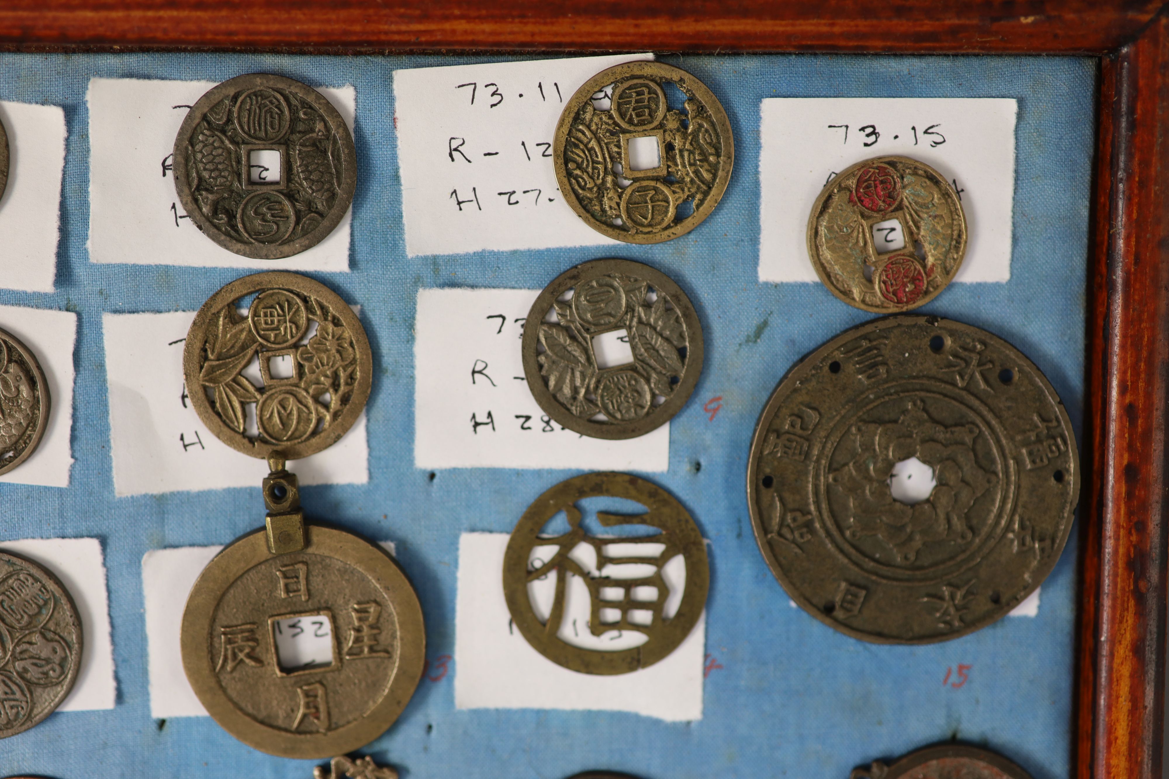 A group of 99 Korean bronze and metal amulets or charms, 19th/20th century